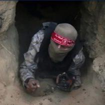 A Hamas fighter emerging from a Gaza tunnel.